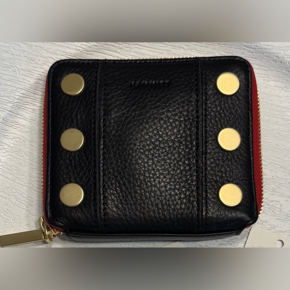 Hammitt 5 North Black Leather Red Zip Wallet with Brushed Gold Accents.